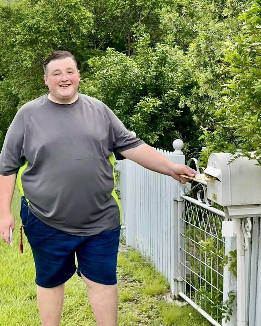 Josh Addison out doorknocking, dropping a flyer in a letterbox in Ipswich